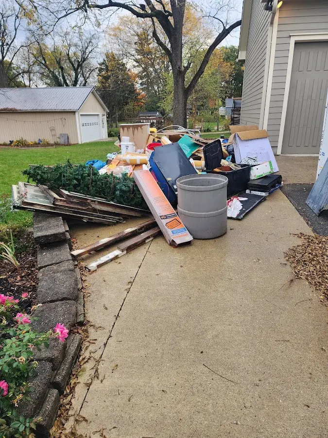 Dumpster being loaded with debris for Residential Dumpster Rental in Auburndale